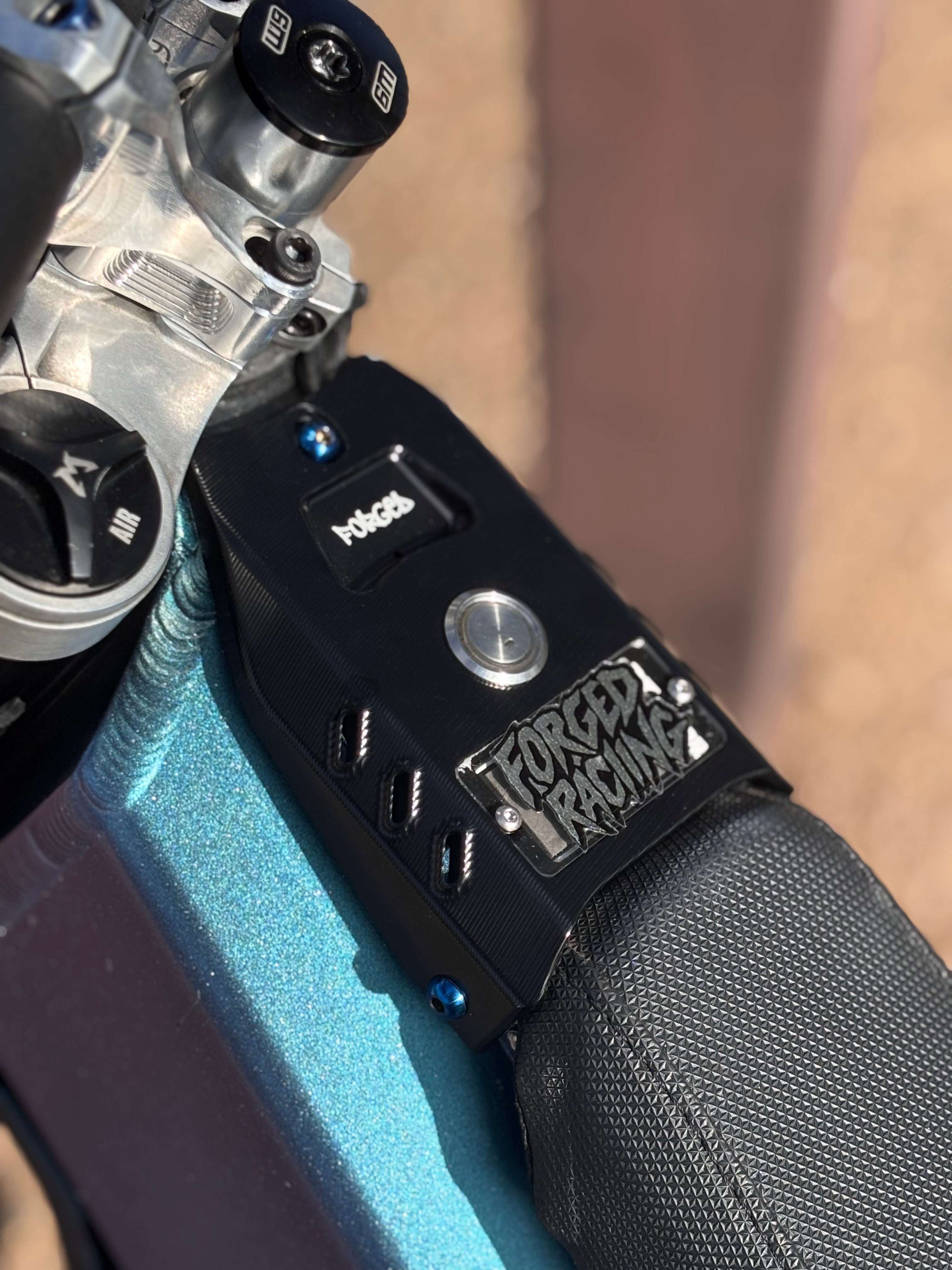 Talaria XXX ignition cover engraved with Forged Racing V2 logo