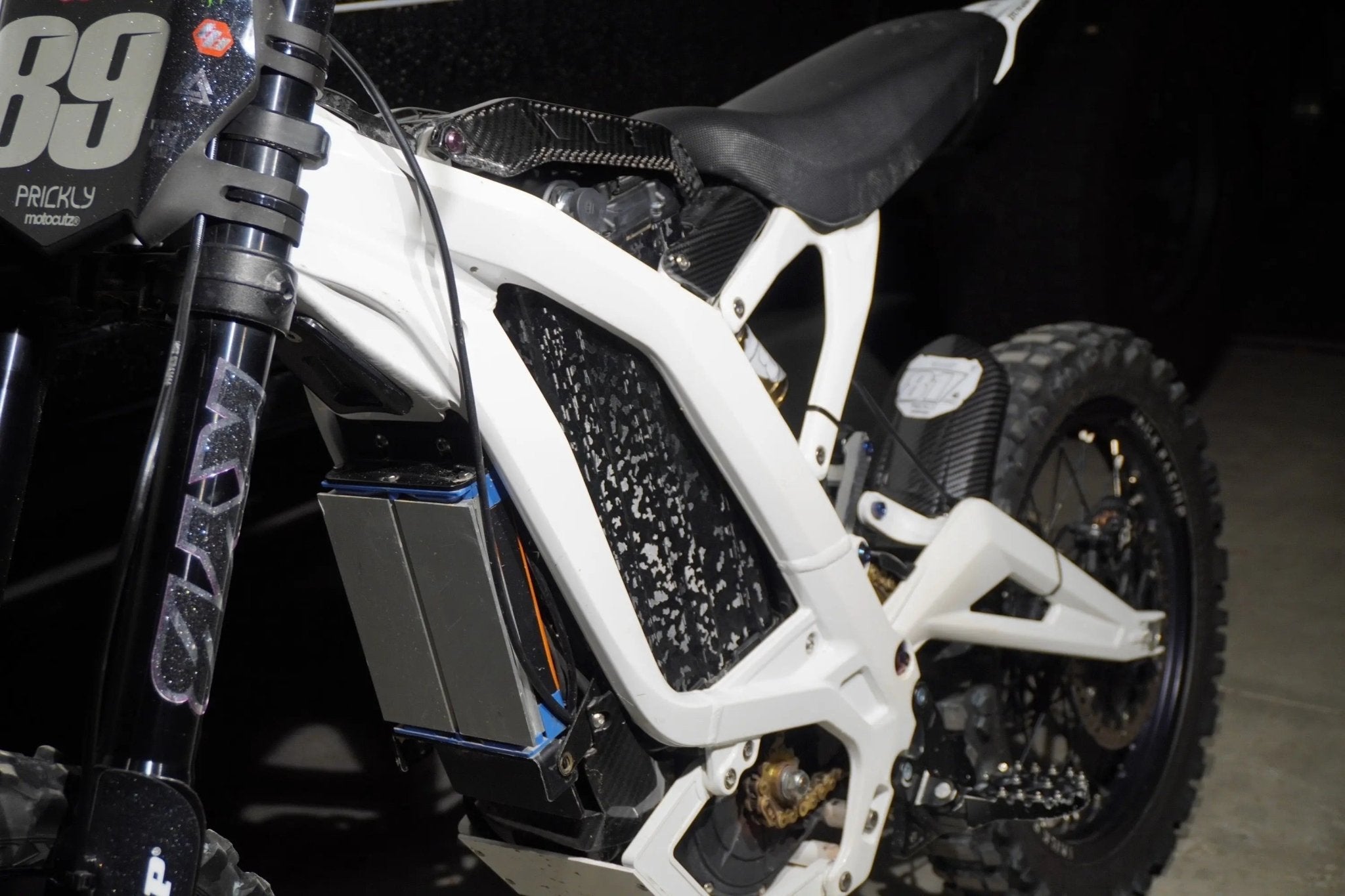 Sur-Ron battery with black camo vinyl wrap installed