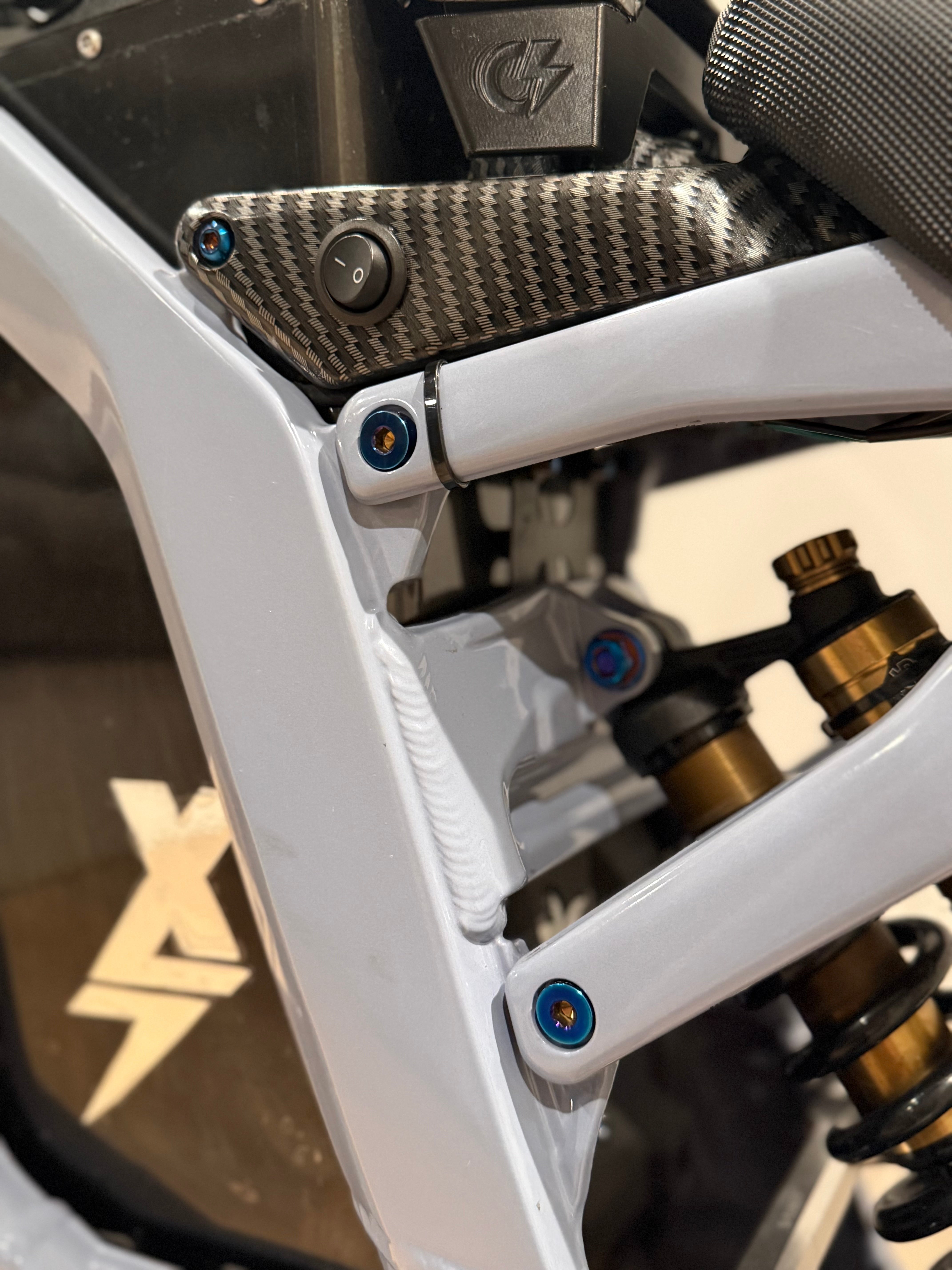 Close-up of titanium subframe bolt threading for e-moto
