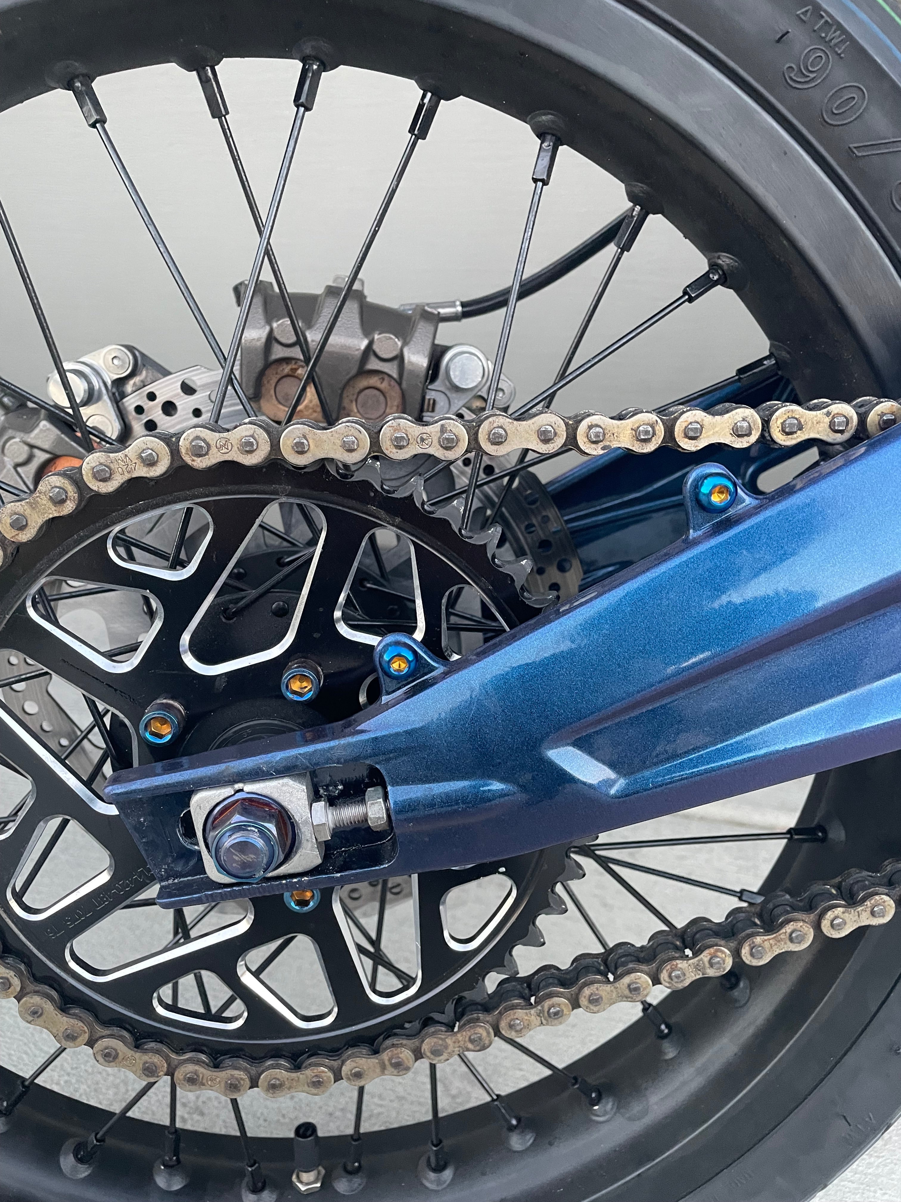 Two-piece titanium chain guard bolt kit for e-moto
