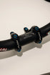 Titanium stem bolts arranged next to a direct mount stem