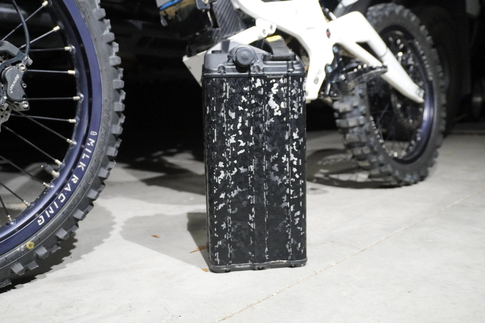Textured black camo wrap applied to an e-moto battery