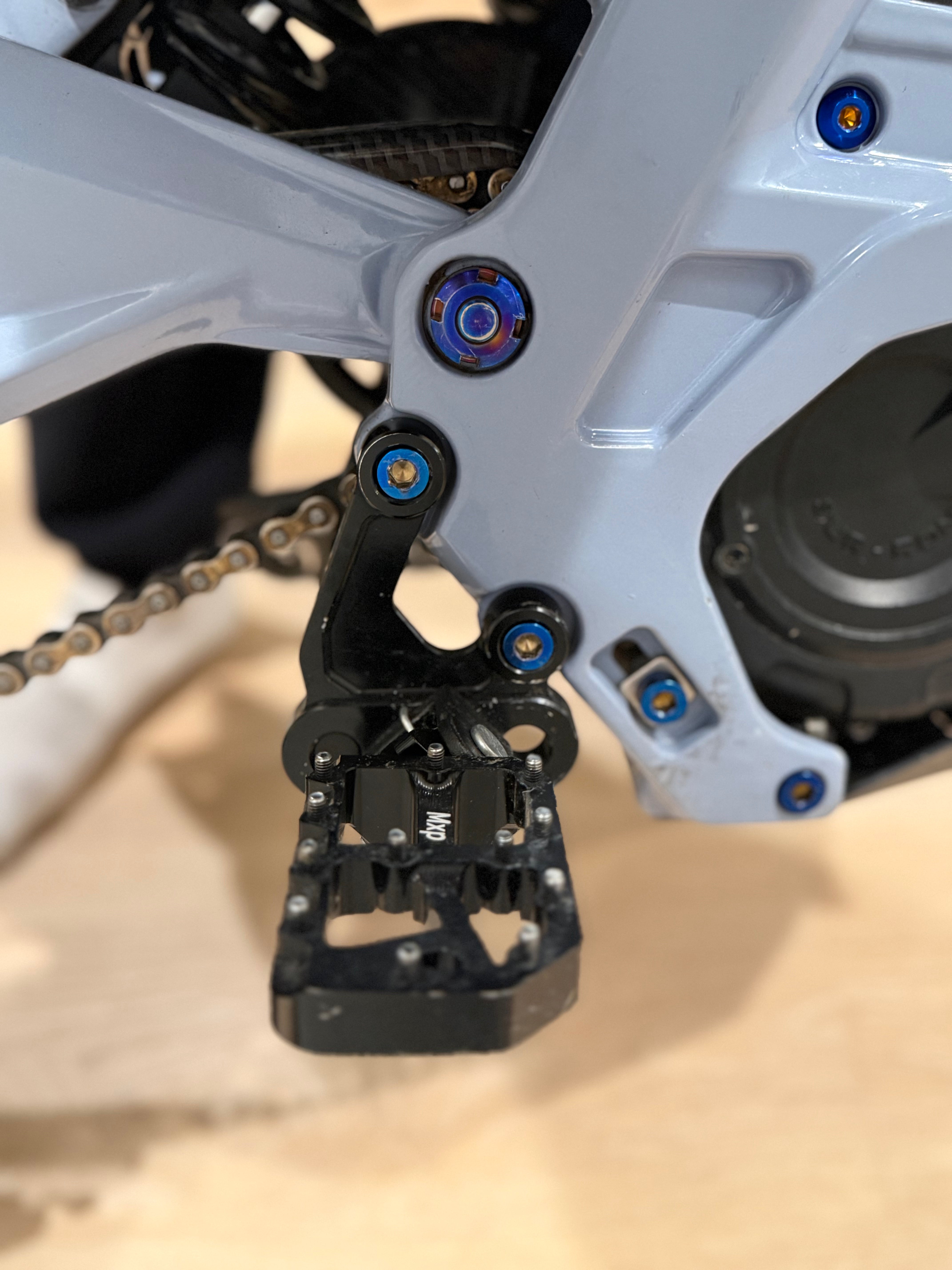 Titanium peg bracket bolts laid out in a set