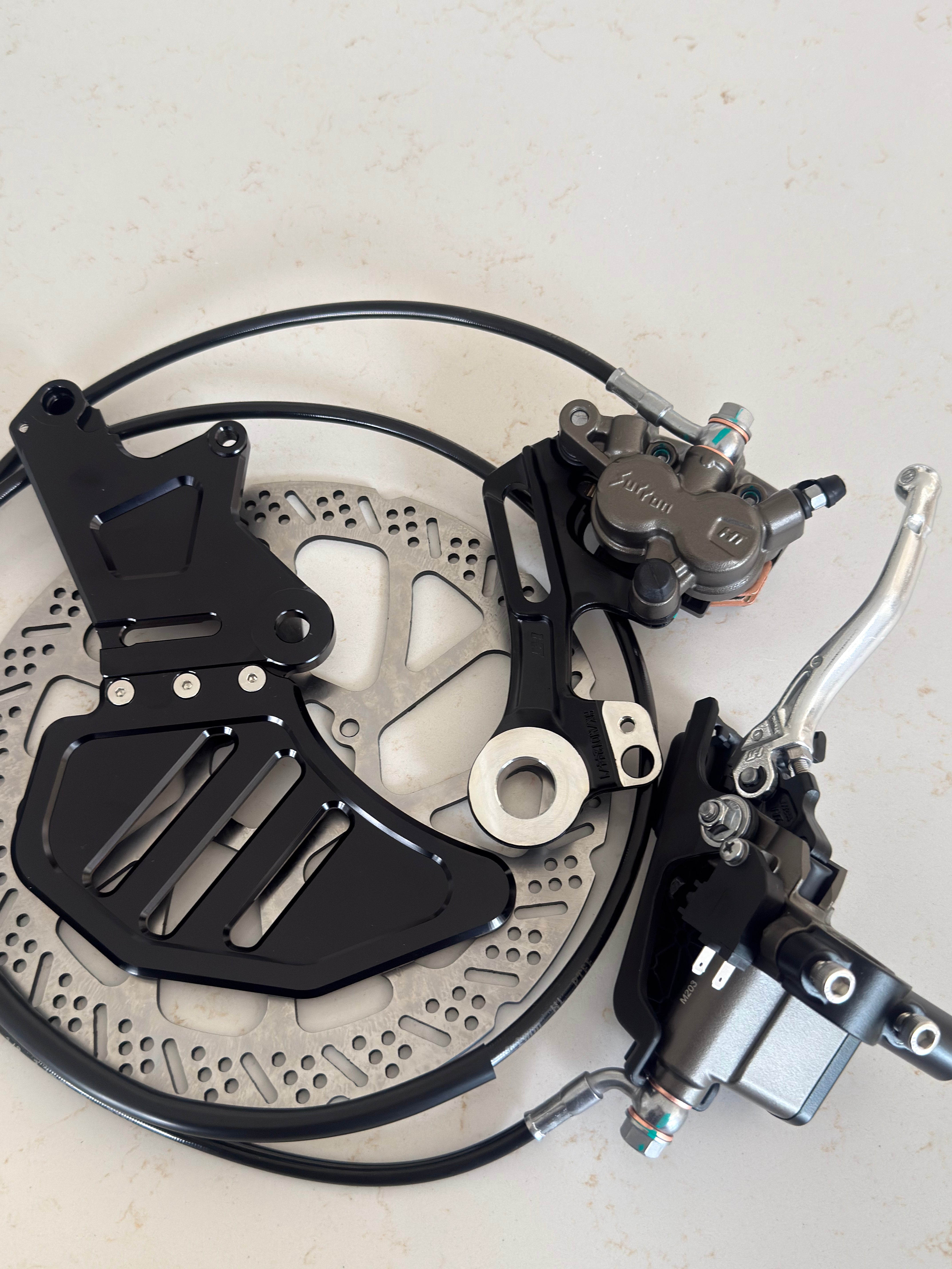 Rear brake kit installed on a Sur-Ron Light Bee swingarm