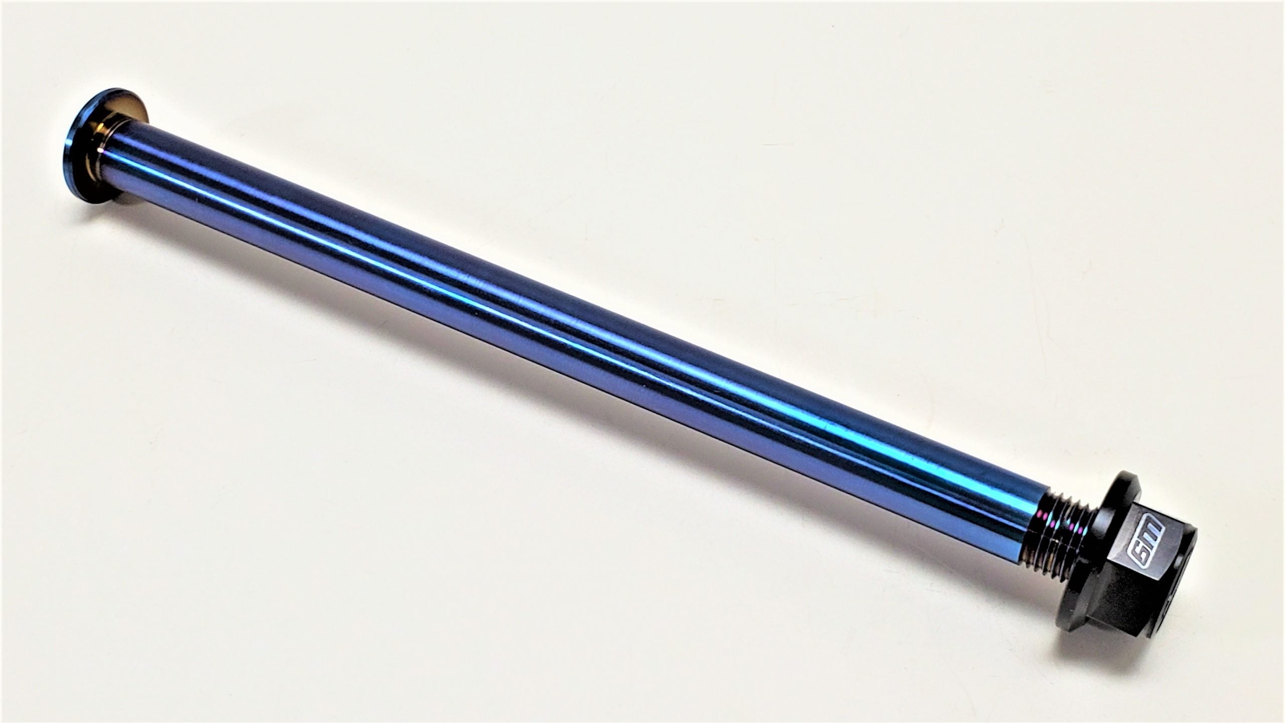 Warp 9 burnt-blue titanium rear axle with Fuji lock nut for Sur-Ron Light Bee