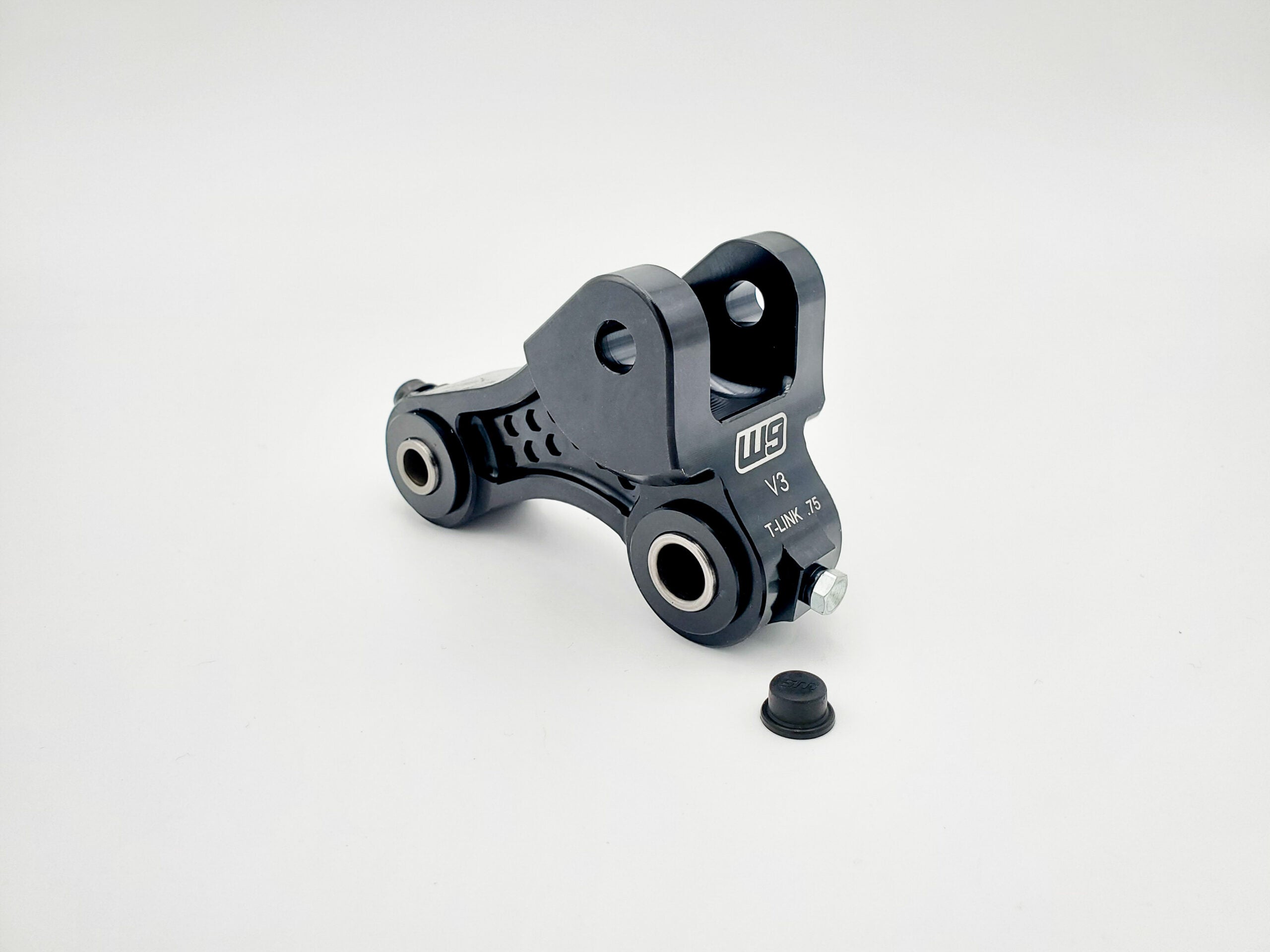 Grease ports and dust caps on Warp 9 serviceable Talaria suspension linkage